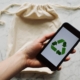 Free Faceless person showing recycle symbol on mobile phone screen Stock Photo