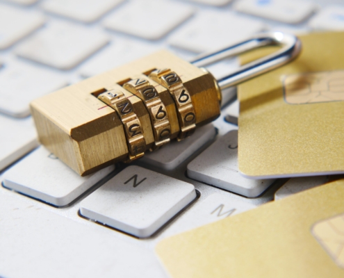 a golden padlock sitting on top of a keyboard